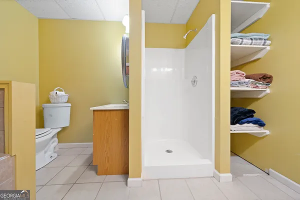 a bathroom with a toilet and a shower