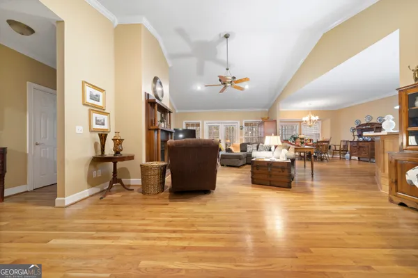 a living room with lots of furniture and a chandelier