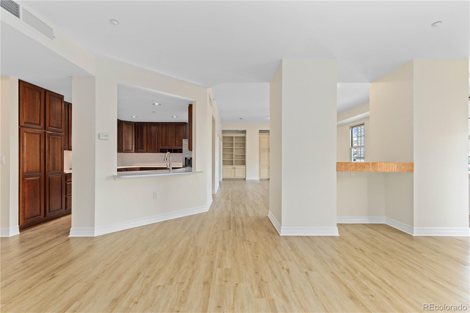 475 West 12th Avenue, Unit 6G Denver, CO 80204 - Photo 11 of 44 a view of a hallway with wooden floor and a living room