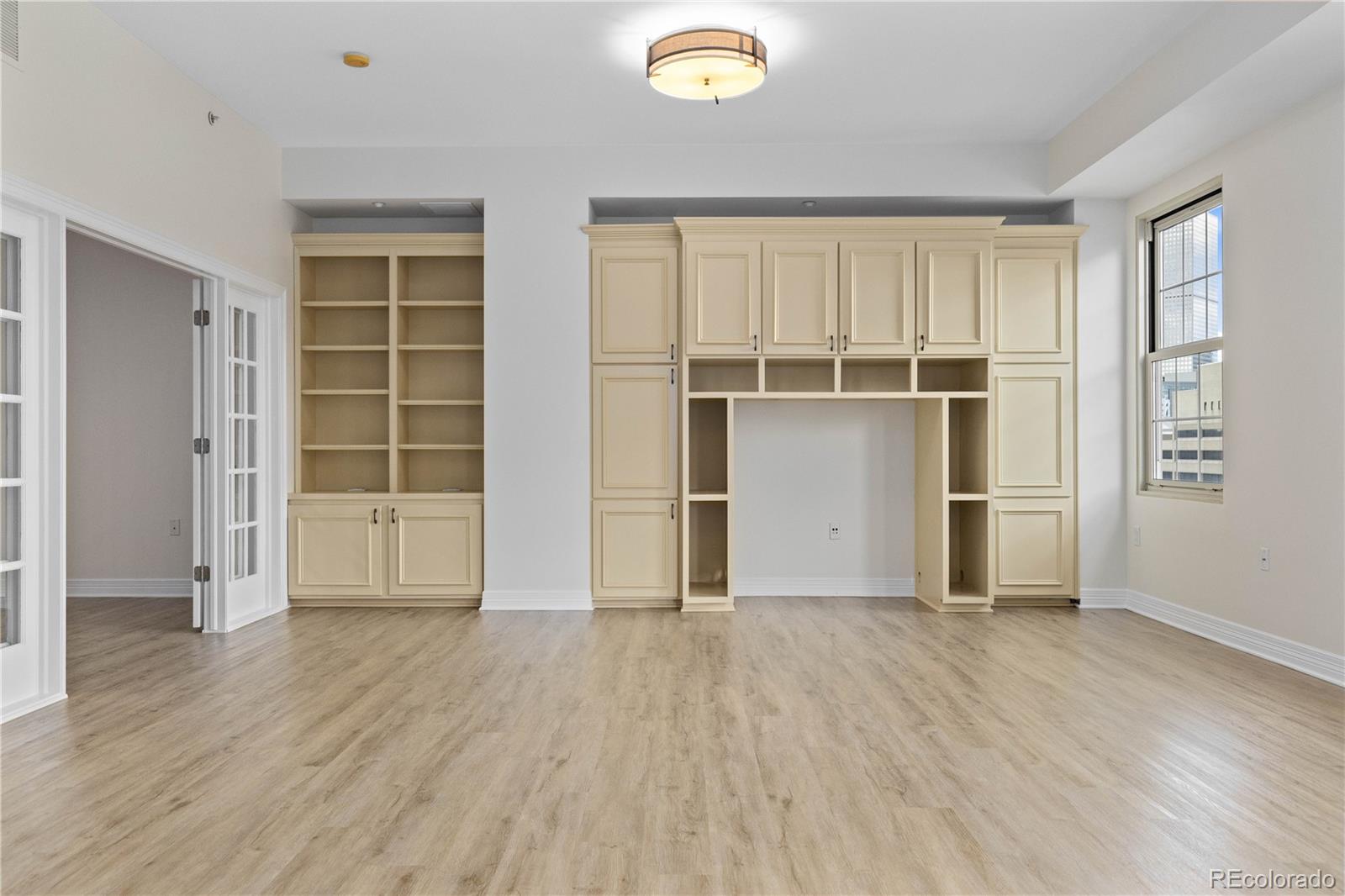 475 West 12th Avenue, Unit 6G Denver, CO 80204 - Photo 13 of 44 an empty room with wooden floor and windows