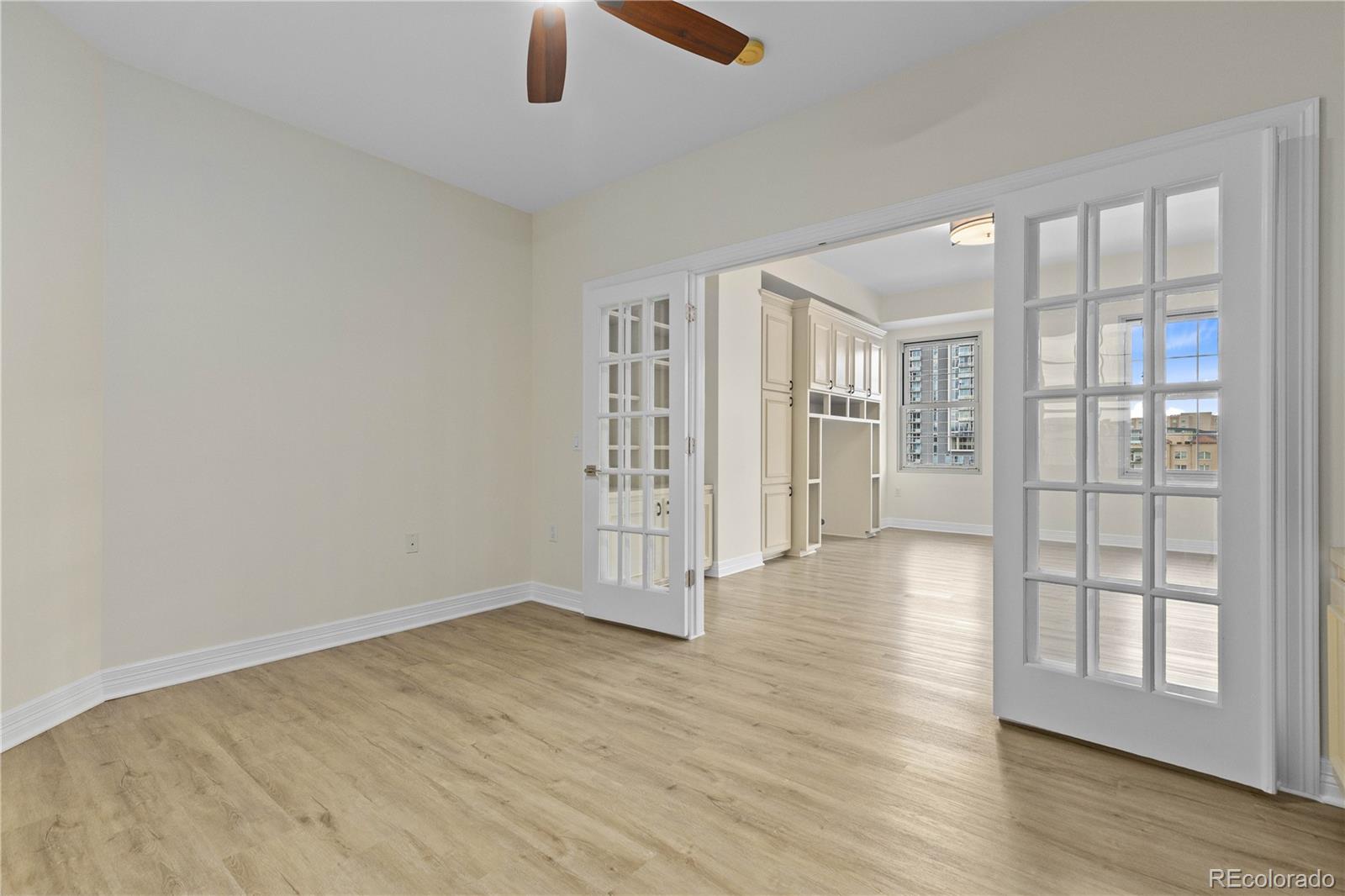475 West 12th Avenue, Unit 6G Denver, CO 80204 - Photo 14 of 44 an empty room with wooden floor and windows