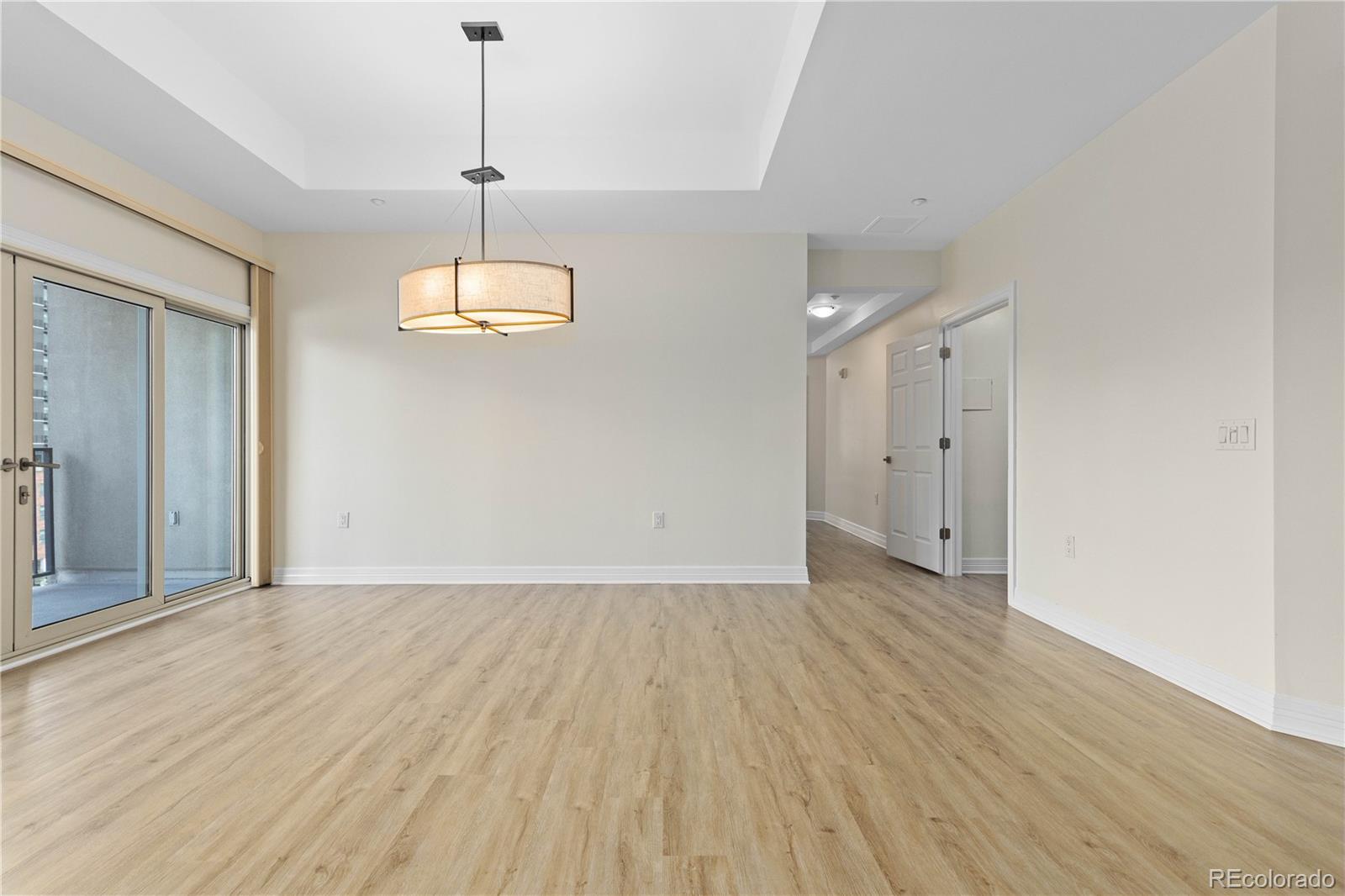 475 West 12th Avenue, Unit 6G Denver, CO 80204 - Photo 17 of 44 a view of an empty room with wooden floor and a window