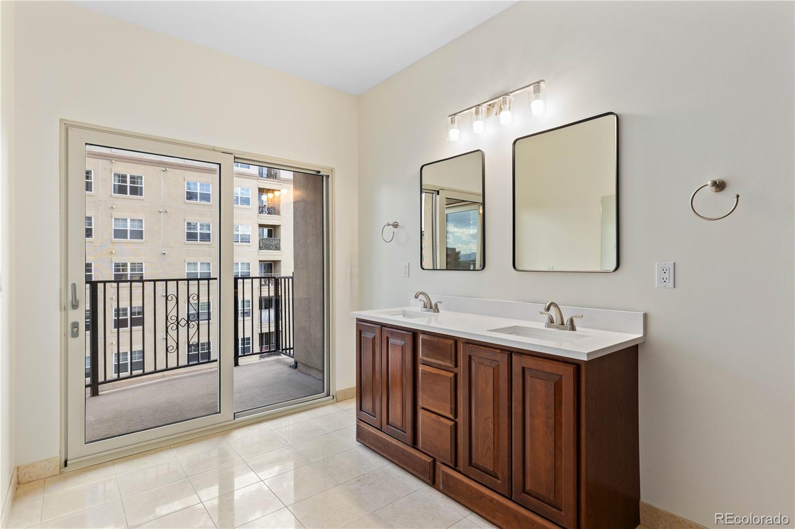 475 West 12th Avenue, Unit 6G Denver, CO 80204 - Photo 23 of 44 a spacious bathroom with a double vanity sink and a mirror