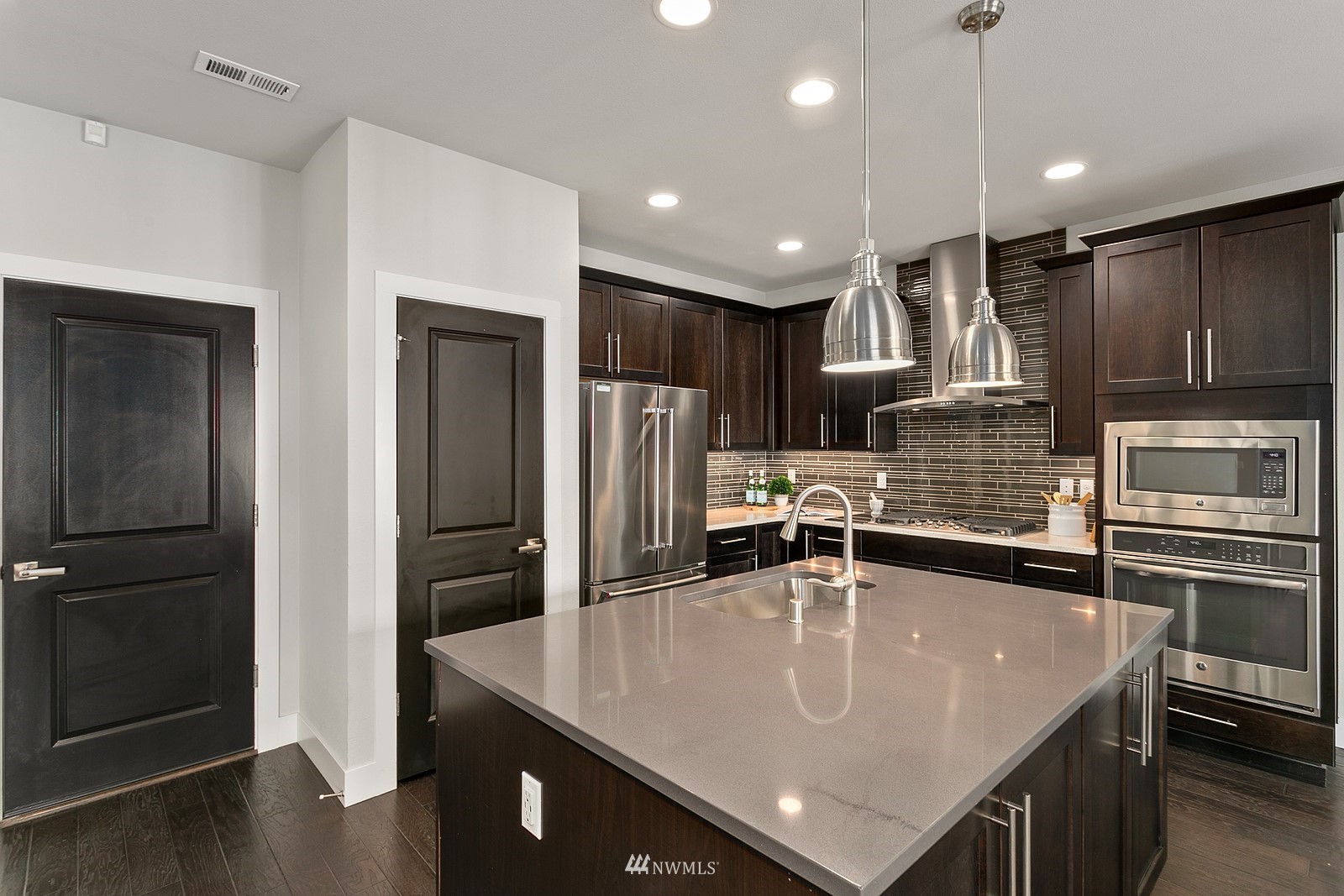 20527 Richmond Road Bothell, WA 98012 - Photo 11 of 40 a kitchen with stainless steel appliances granite countertop a sink a stove and refrigerator