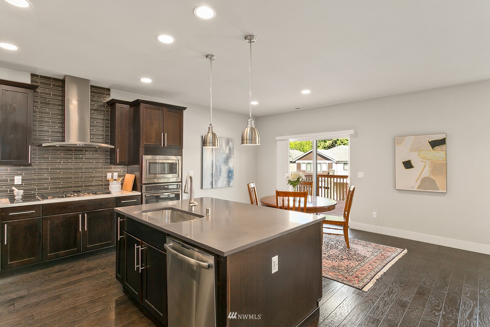 20527 Richmond Road Bothell, WA 98012 - Photo 13 of 40 a kitchen with stainless steel appliances granite countertop a sink a stove and a refrigerator
