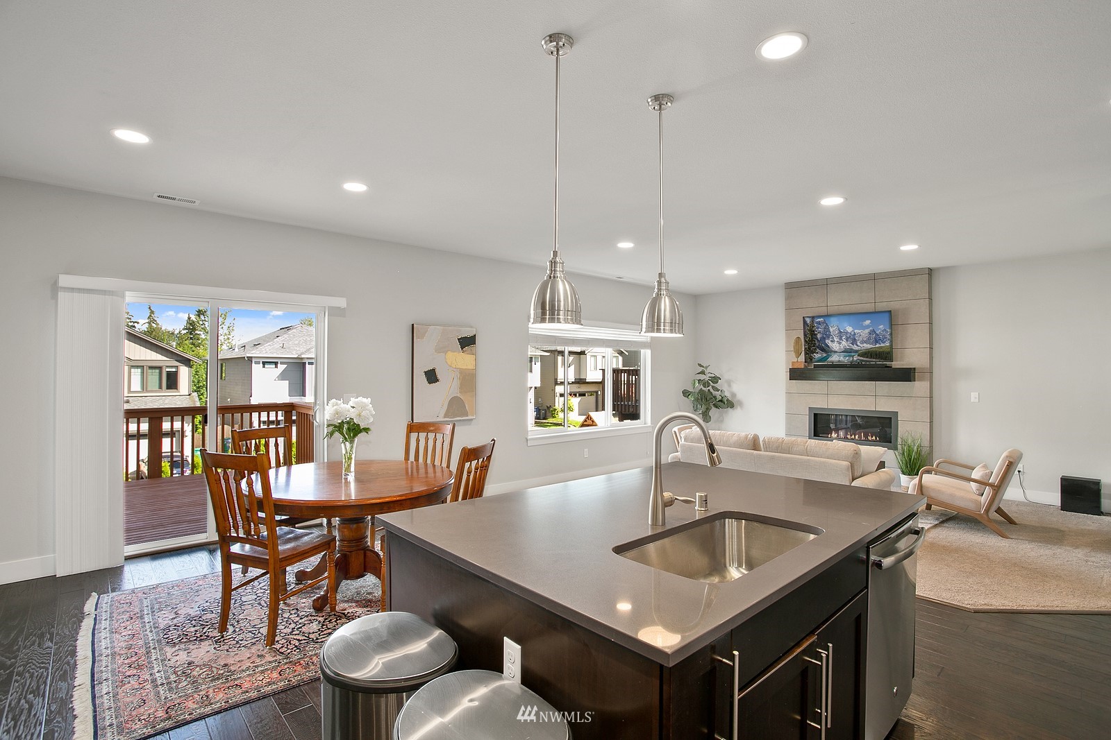 20527 Richmond Road Bothell, WA 98012 - Photo 14 of 40 a kitchen with a table chairs sink and wooden floor