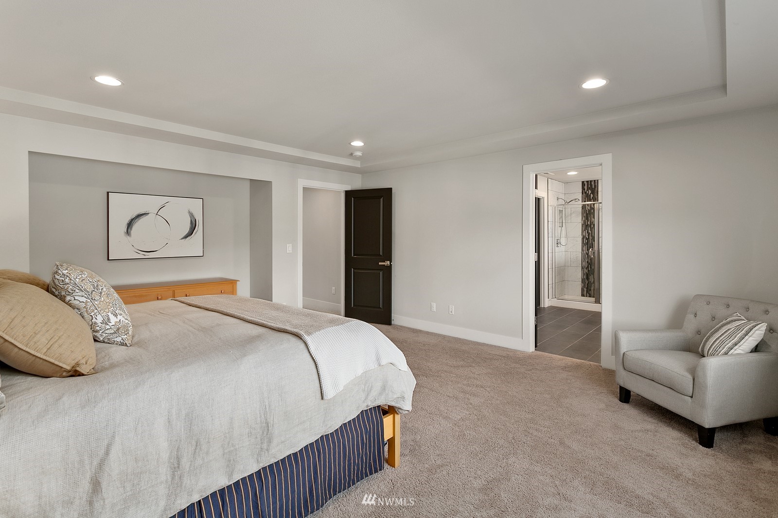 20527 Richmond Road Bothell, WA 98012 - Photo 18 of 40 a bedroom with a bed and glass walk in closet