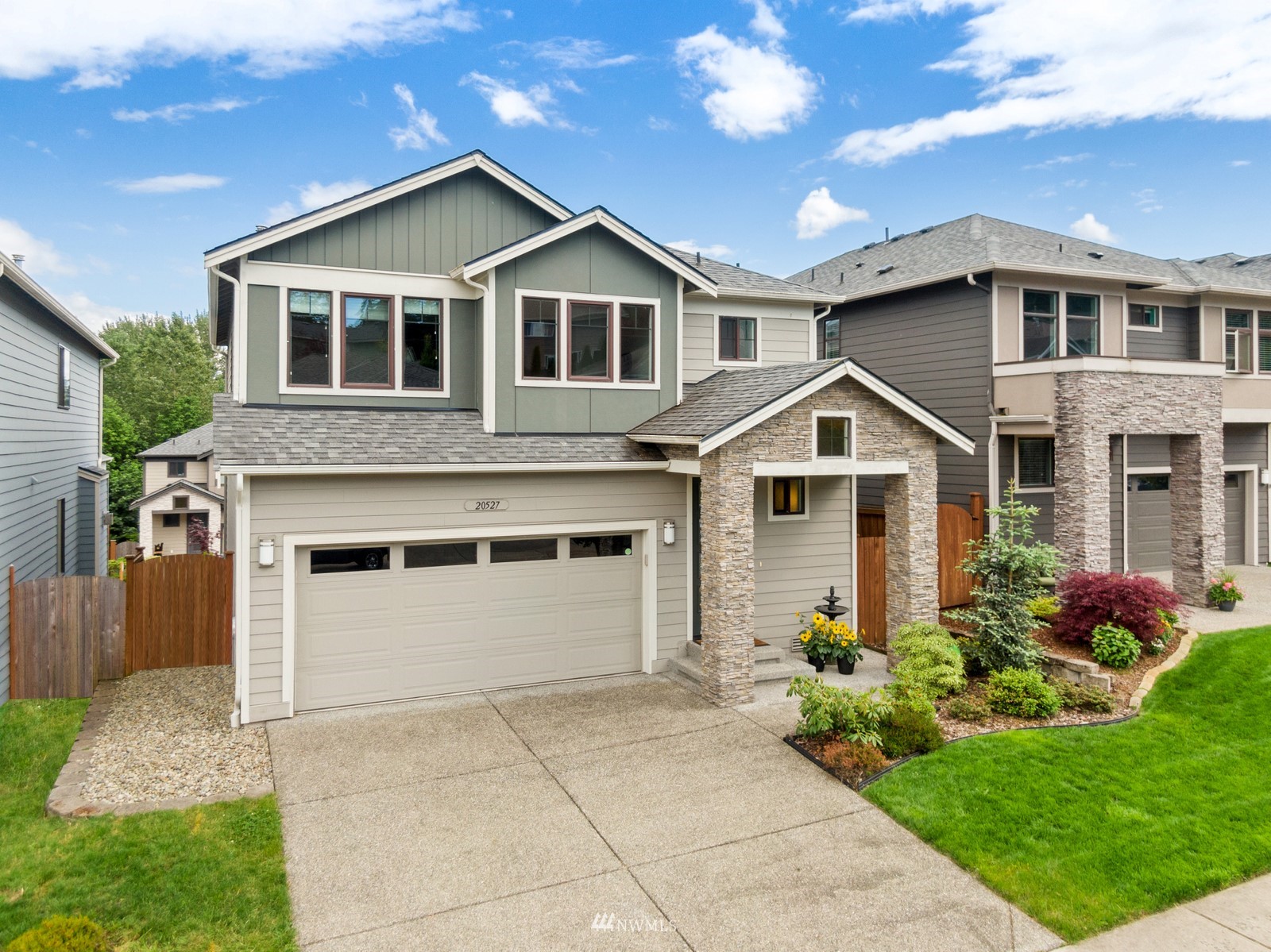 20527 Richmond Road Bothell, WA 98012 - Photo 2 of 40 a front view of a house with a yard and garage