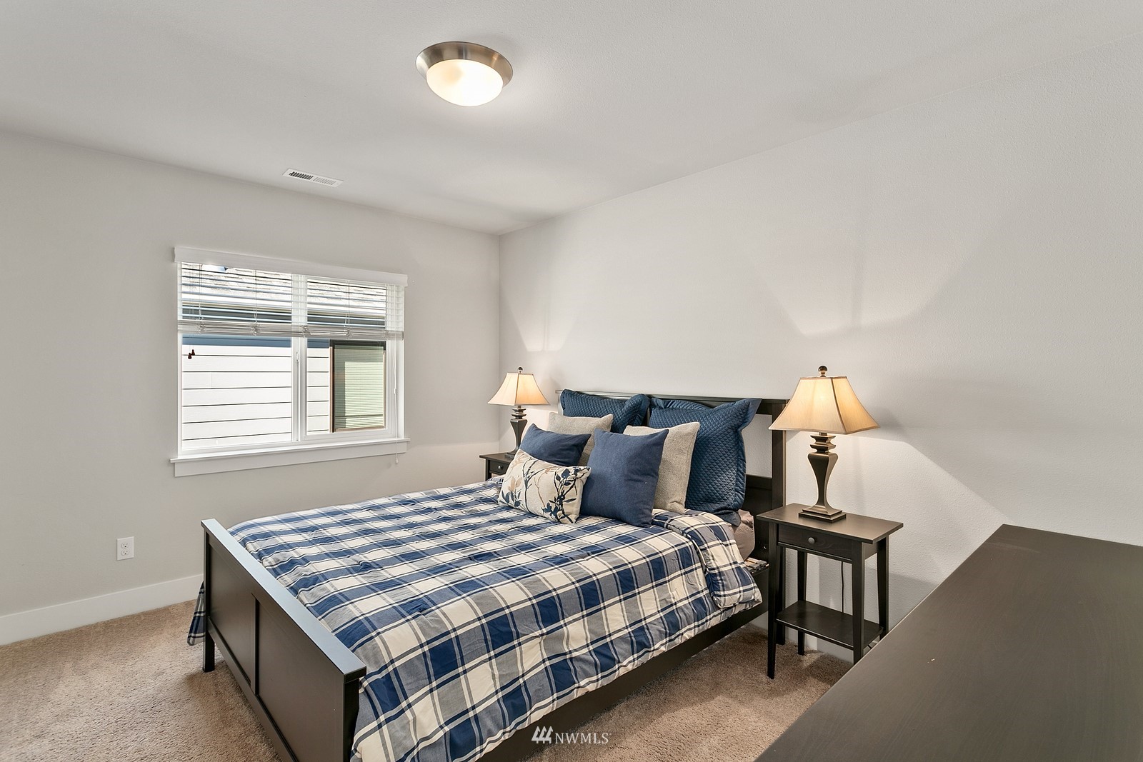 20527 Richmond Road Bothell, WA 98012 - Photo 21 of 40 a bedroom with a bed and a window