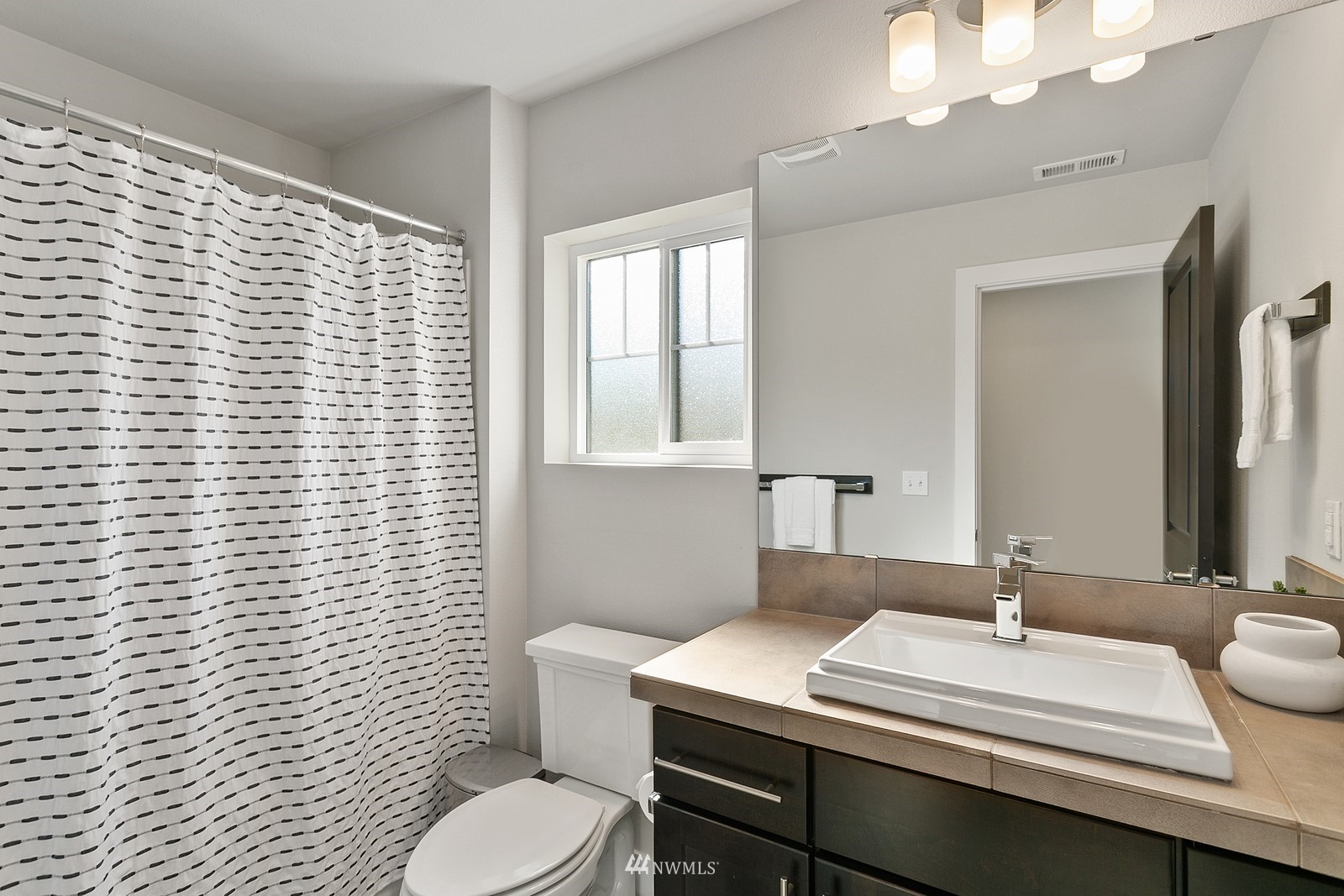 20527 Richmond Road Bothell, WA 98012 - Photo 25 of 40 a bathroom with a sink a toilet and mirror
