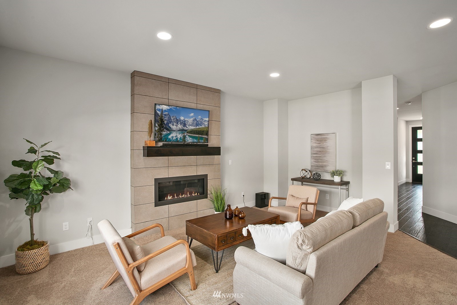 20527 Richmond Road Bothell, WA 98012 - Photo 3 of 40 a living room with furniture a fireplace and a potted plant