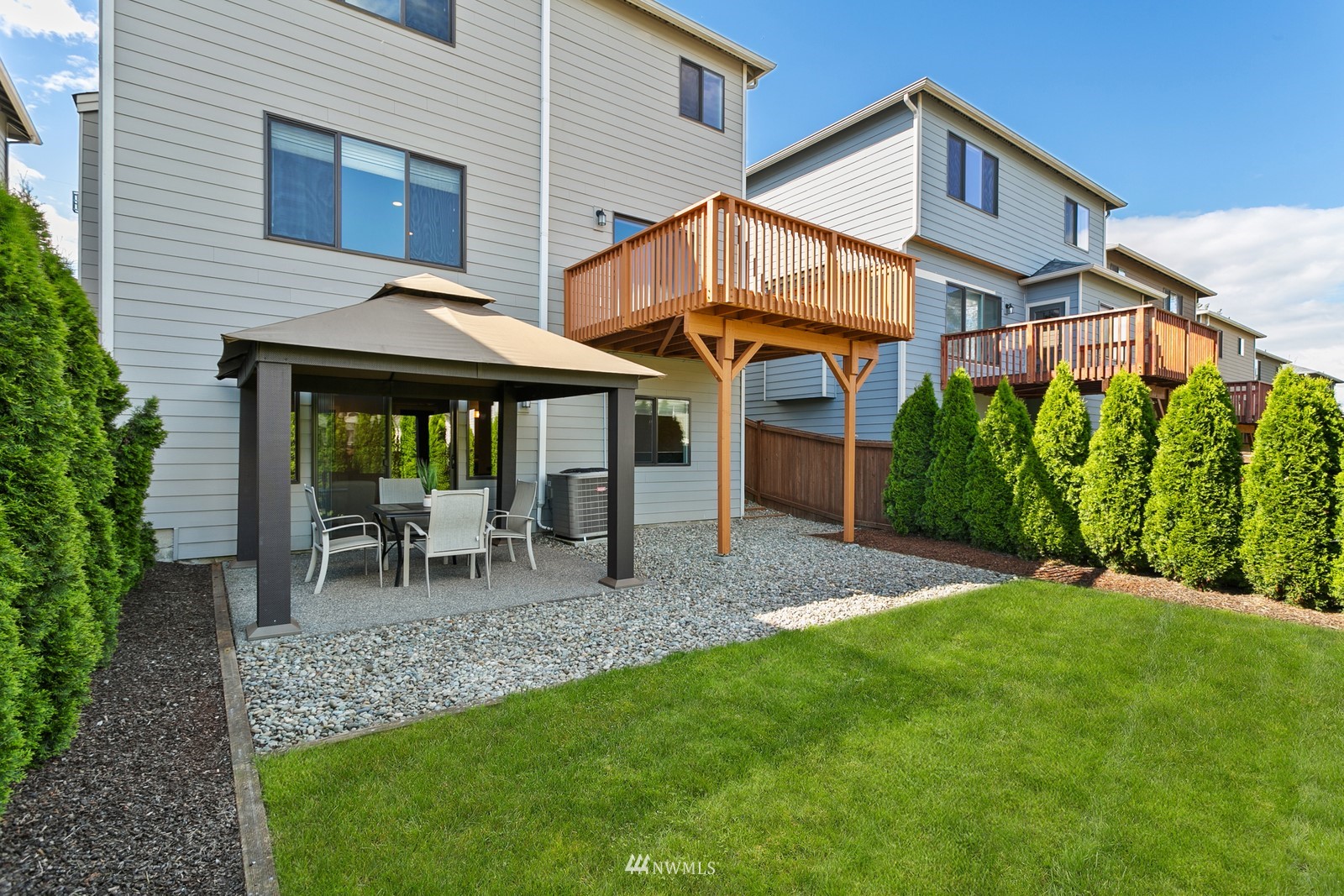 20527 Richmond Road Bothell, WA 98012 - Photo 33 of 40 a view of a house with a yard chairs and table in the patio