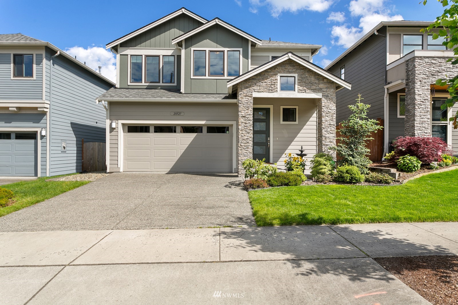 20527 Richmond Road Bothell, WA 98012 - Photo 36 of 40 a front view of a house with a yard and garage