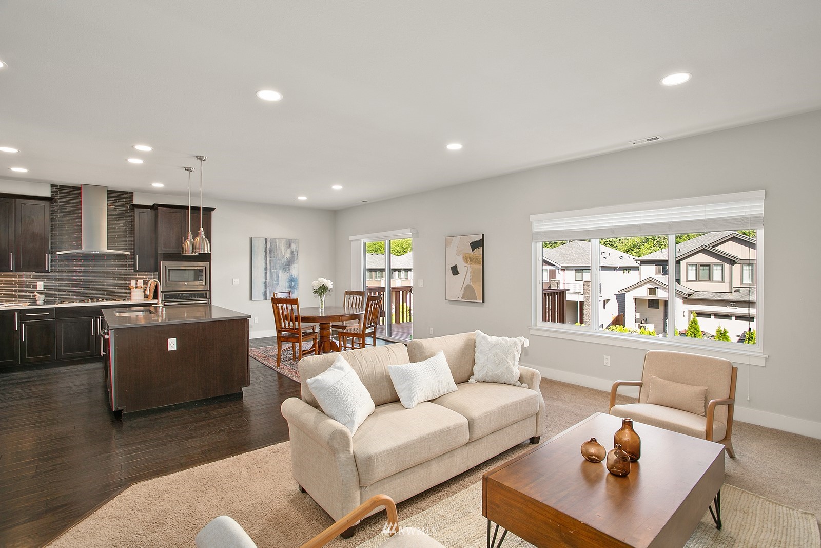 20527 Richmond Road Bothell, WA 98012 - Photo 6 of 40 a living room with stainless steel appliances kitchen island granite countertop furniture and a wooden floor