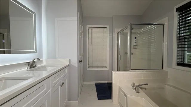 a bathroom with a tub and a sink