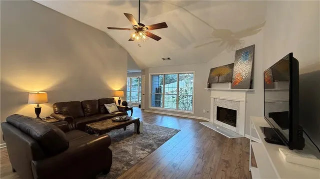 a living room with furniture fireplace and flat screen tv