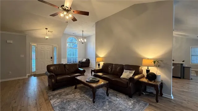 a living room with furniture and wooden floor