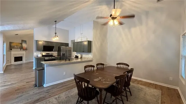a view of a dining room with furniture and wooden floor