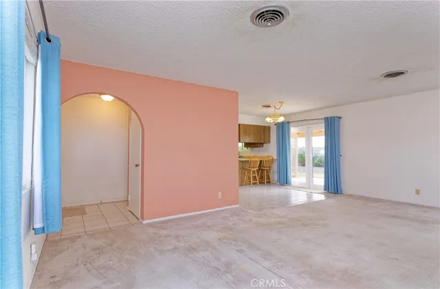 an empty room with closet and windows
