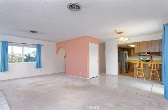 a view of a kitchen with refrigerator and microwave
