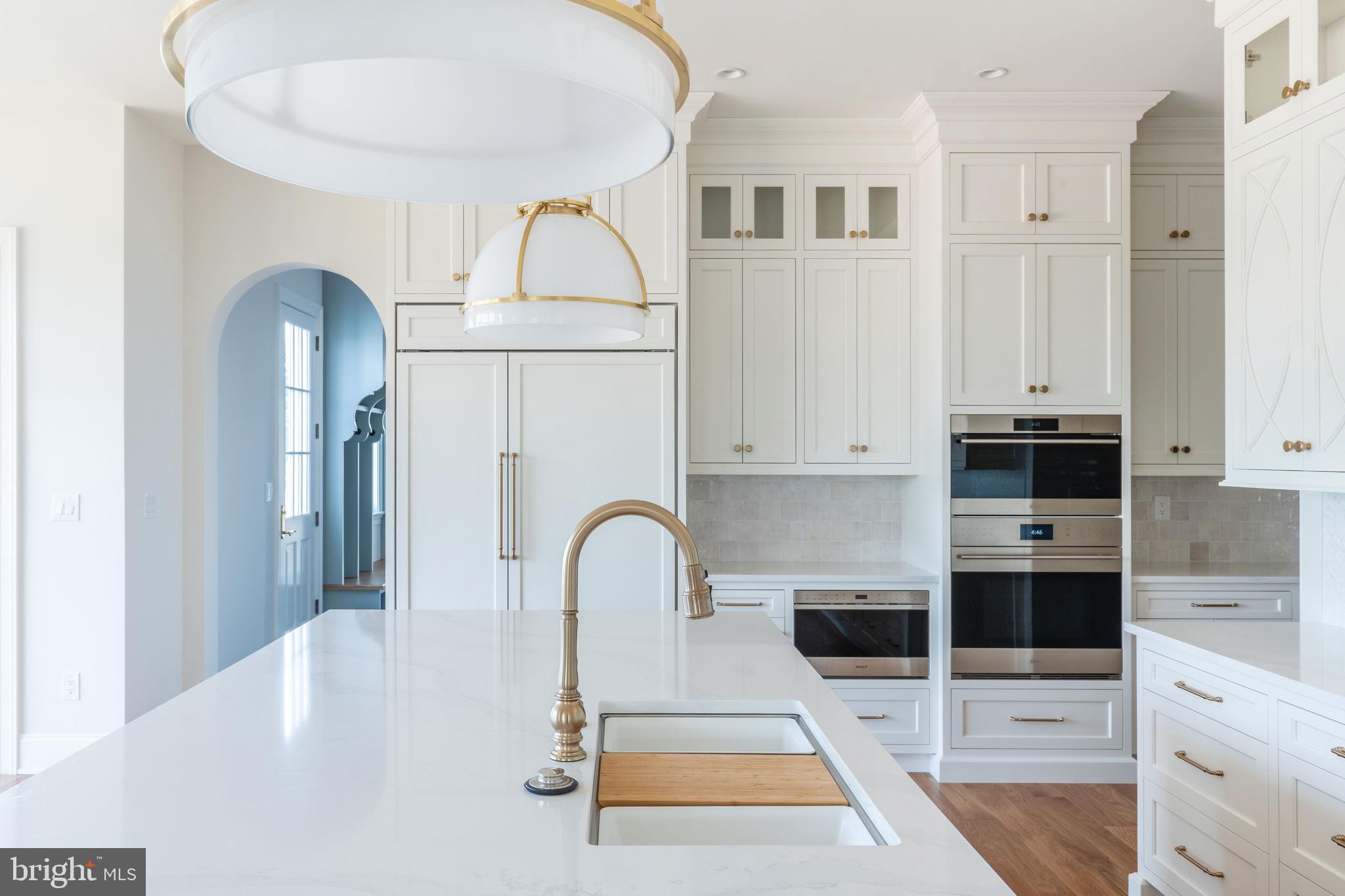 406 Barclay Road Bryn Mawr, PA 19010 - Photo 11 of 26 a kitchen with stainless steel appliances a stove a sink and white cabinets
