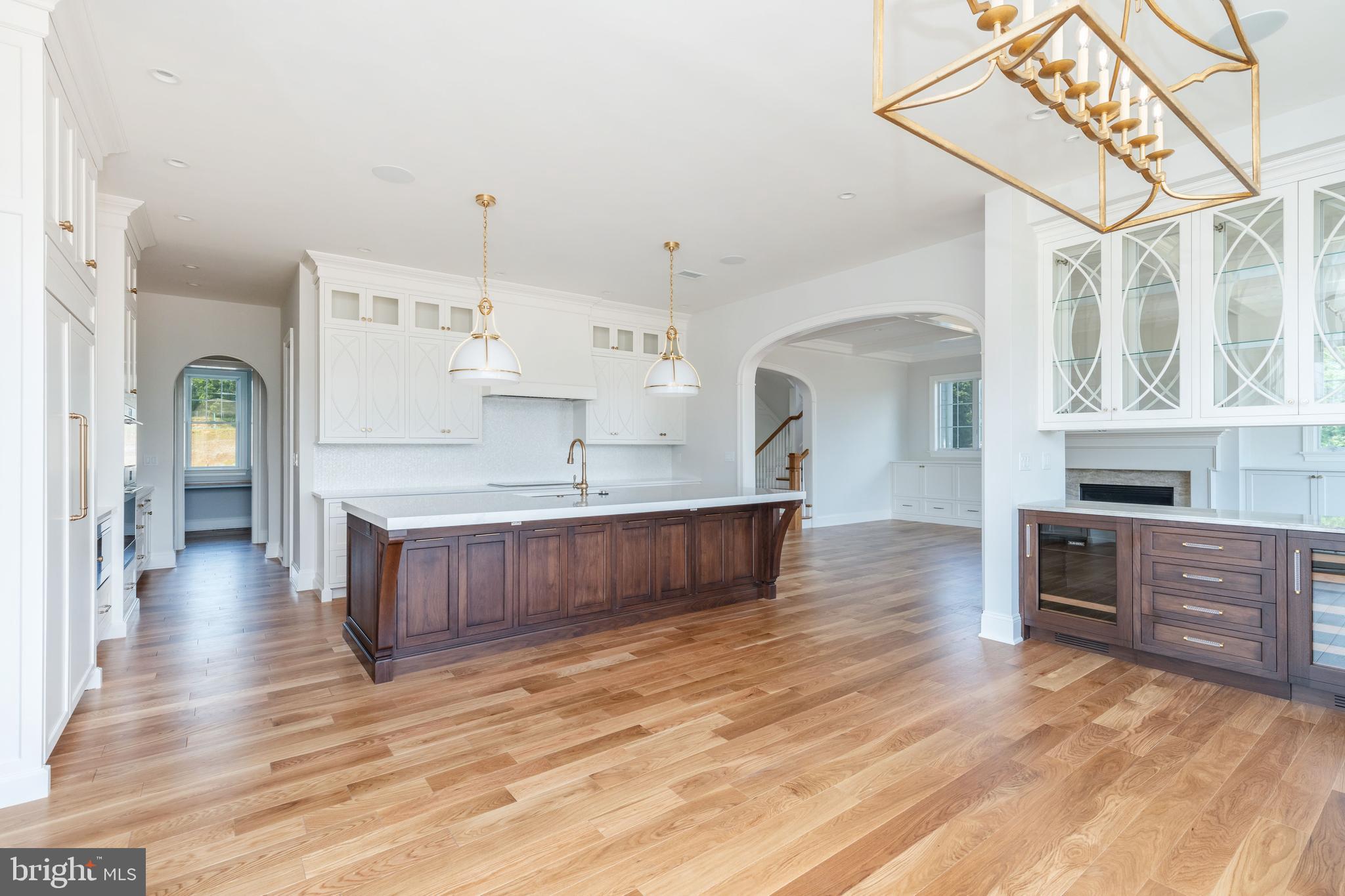 406 Barclay Road Bryn Mawr, PA 19010 - Photo 9 of 26 a large kitchen with stainless steel appliances granite countertop a large counter top a sink a stove and a wooden floors