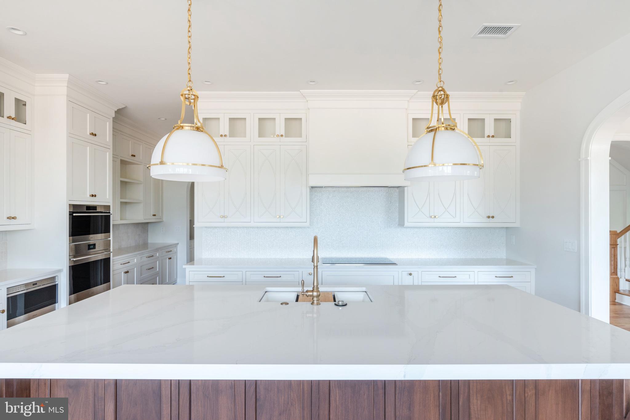 406 Barclay Road Bryn Mawr, PA 19010 - Photo 10 of 26 a kitchen with kitchen island a stove a sink and a refrigerator