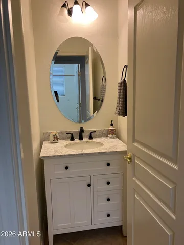 a bathroom with a sink mirror and vanity