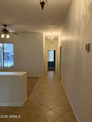 a view of a hallway with paintings on the wall