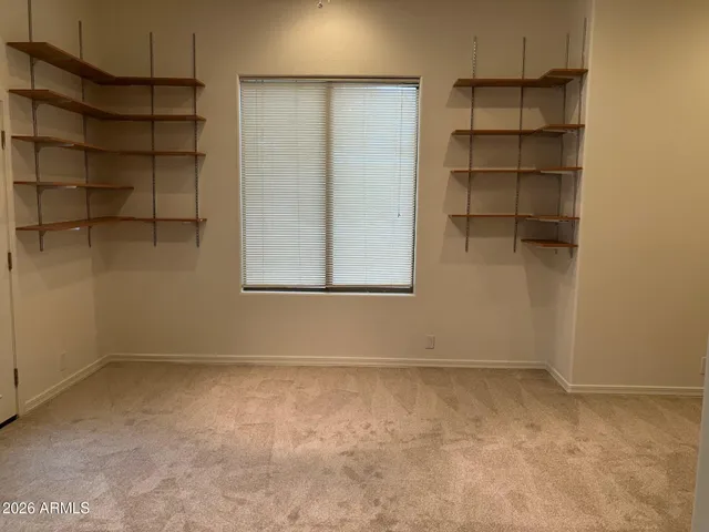 a view of an empty room with a cabinet