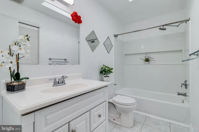 a large bed sitting in a bedroom next to a window