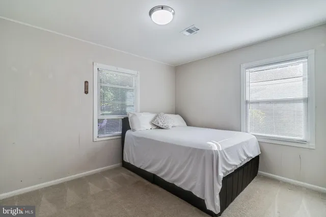 a bedroom with a bed and mirror