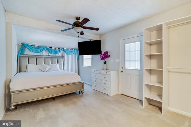 a bedroom with a bed and flat screen tv