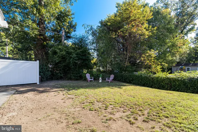 a view of a wooden chairs and fire pit