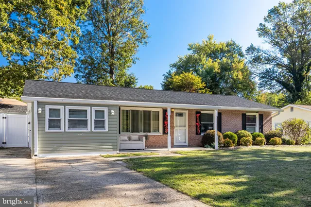 a view of a house with a patio and a yard
