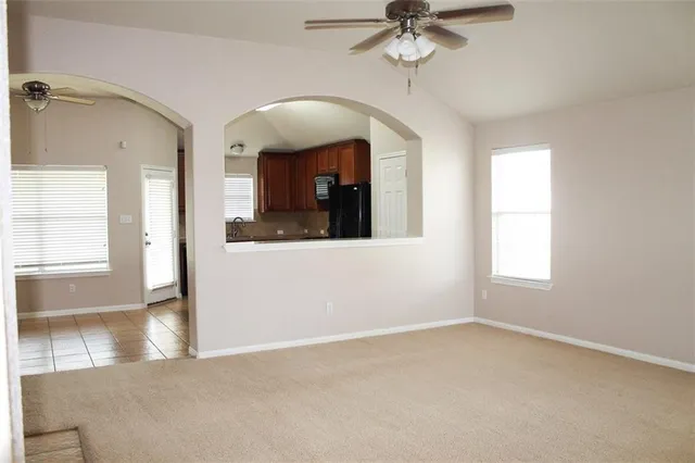 a view of a room with a window and a ceiling fan
