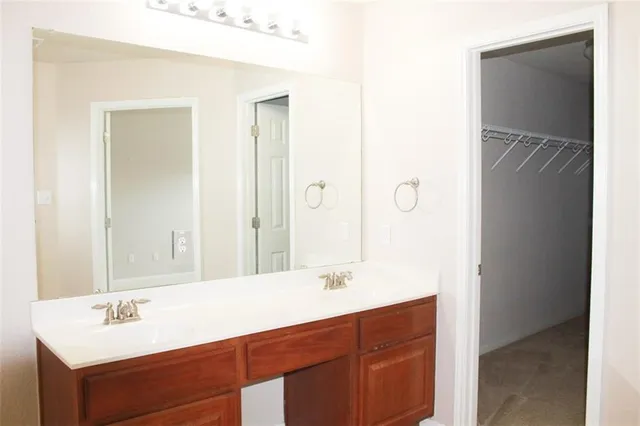 a bathroom with a sink vanity granite tub and shower