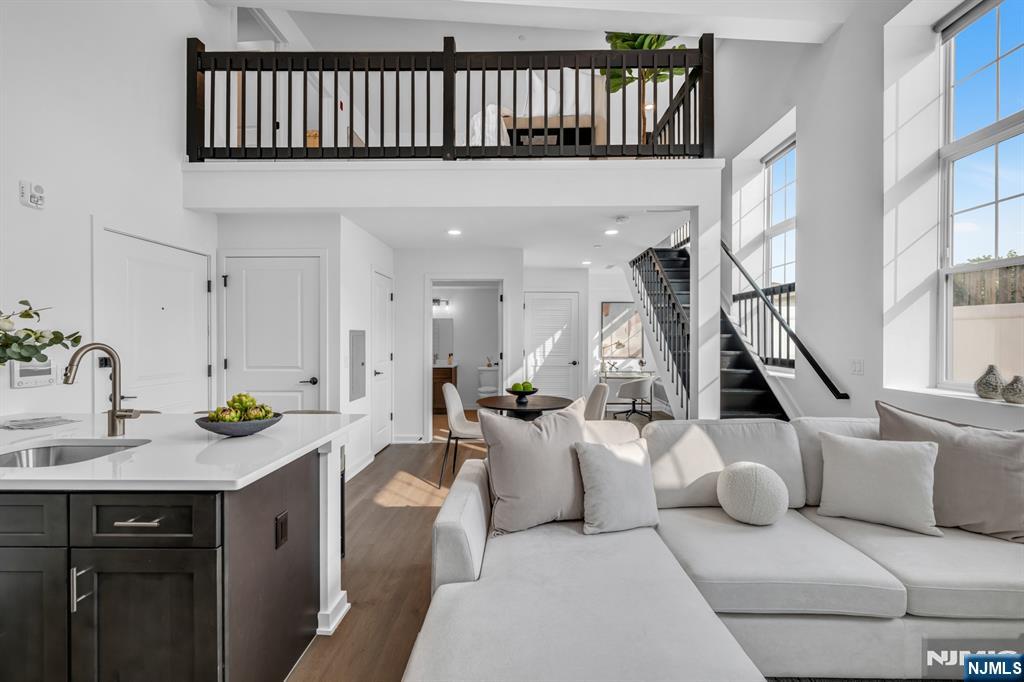 a living room with furniture a rug and a chandelier