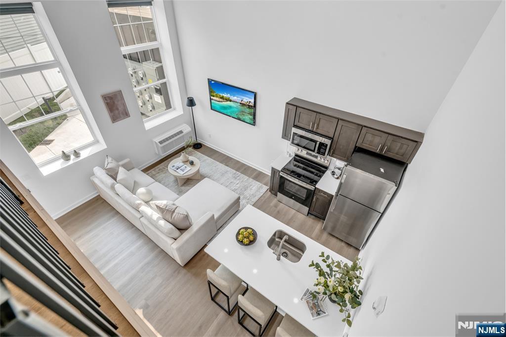 315 Railroad Avenue, Unit 114 East Rutherford, NJ 07073 - Photo 20 of 28 a living room with furniture and a window