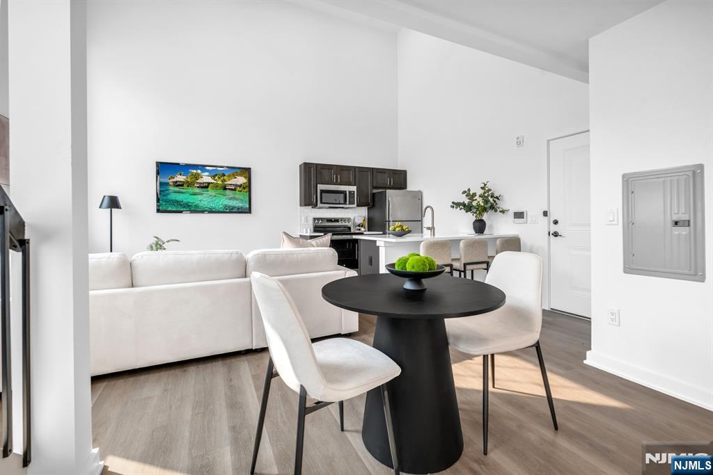 315 Railroad Avenue, Unit 114 East Rutherford, NJ 07073 - Photo 6 of 28 a living room with furniture and a wooden floor