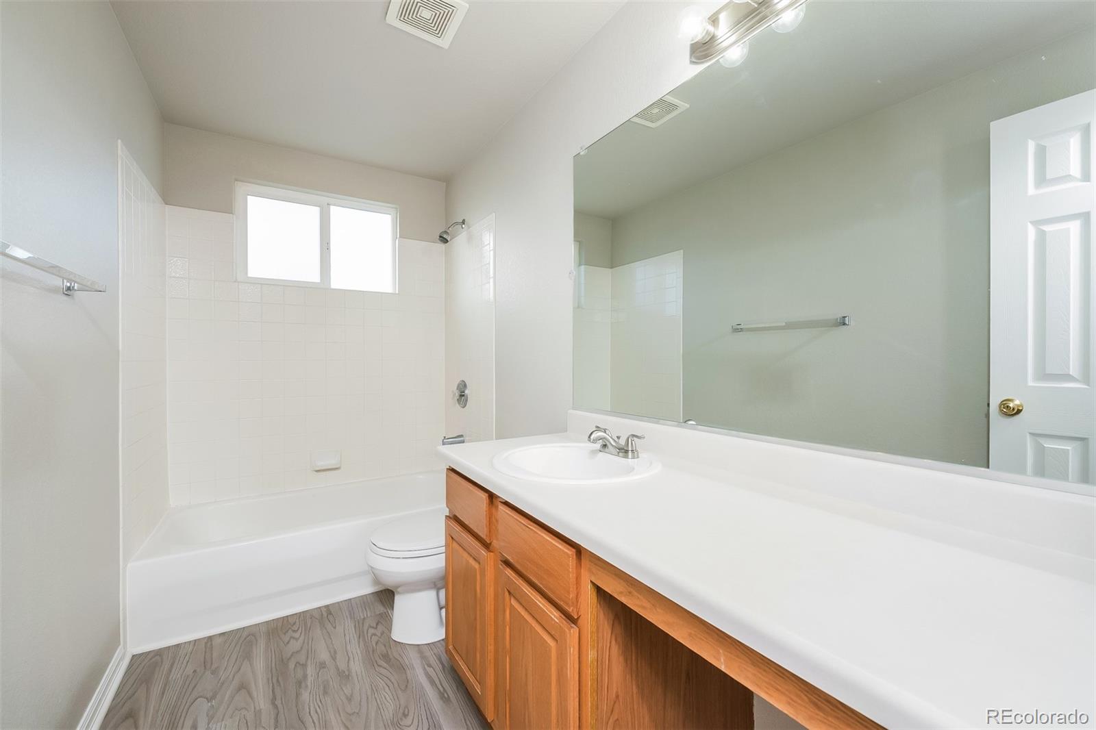 2229 South Truckee Street Aurora, CO 80013 - Photo 11 of 18 a bathroom with a sink a toilet and shower