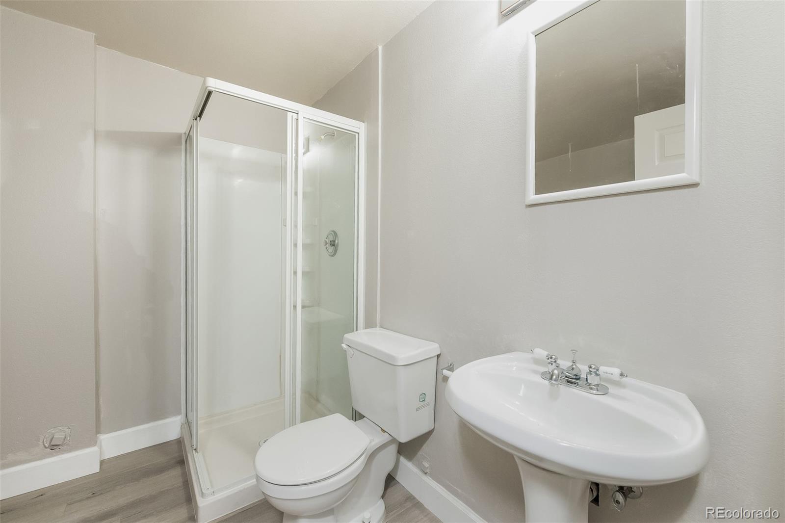 2229 South Truckee Street Aurora, CO 80013 - Photo 13 of 18 a bathroom with a sink a toilet and shower
