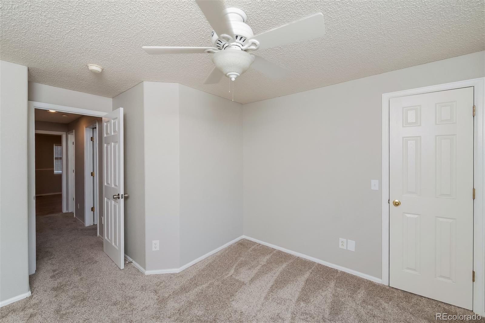 2229 South Truckee Street Aurora, CO 80013 - Photo 9 of 18 wooden floor in an empty room with a bathroom
