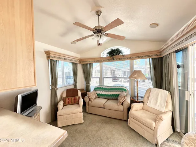 a living room with furniture fireplace and flat screen tv
