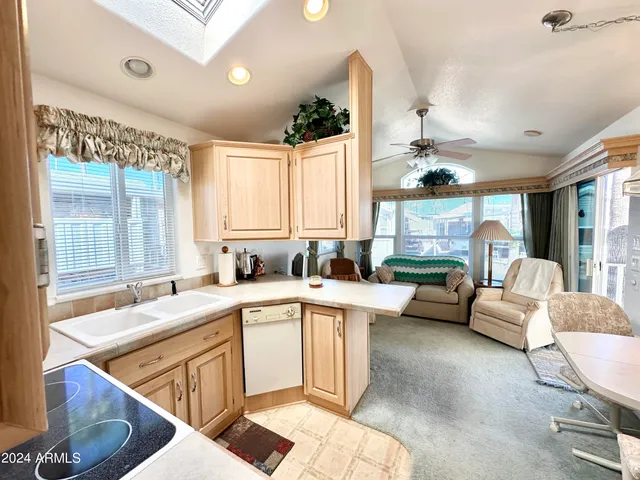 a large white kitchen with a large window