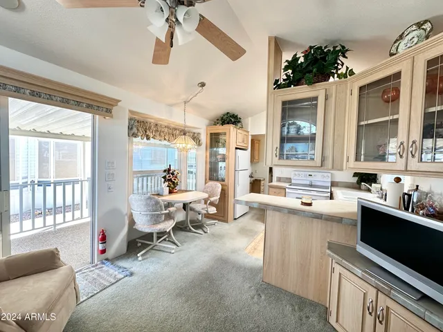 a living room with furniture a window and a chandelier