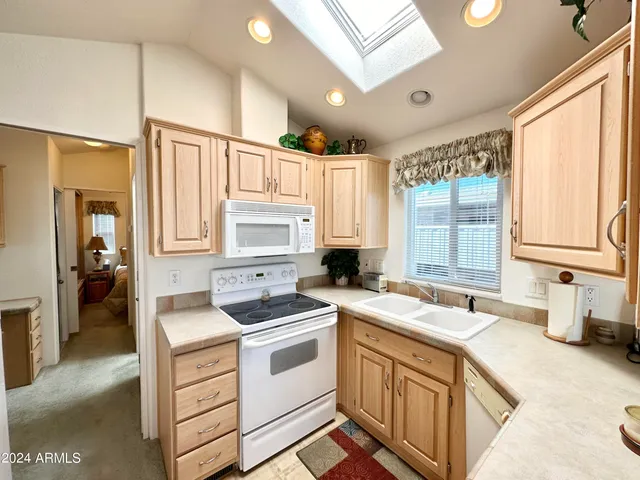a kitchen that has a sink and a stove in it