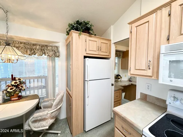 a kitchen with stainless steel appliances a refrigerator sink and wooden floor