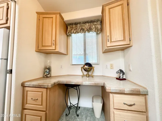 a kitchen with a sink cabinets and a window