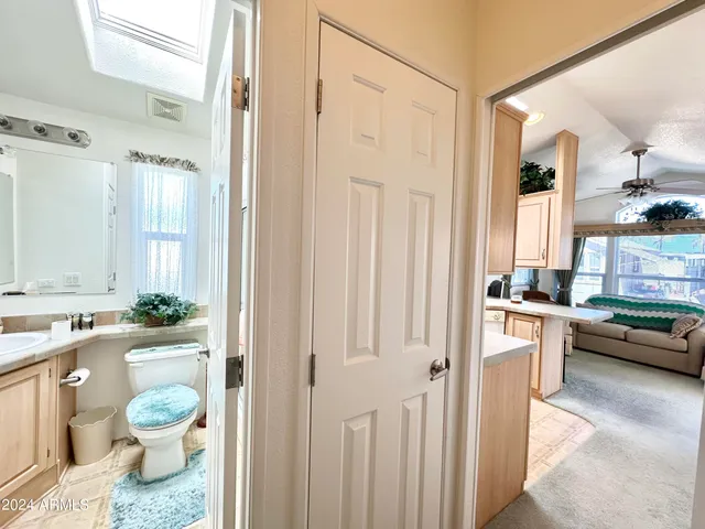 a bathroom with a granite countertop sink a toilet and a shower